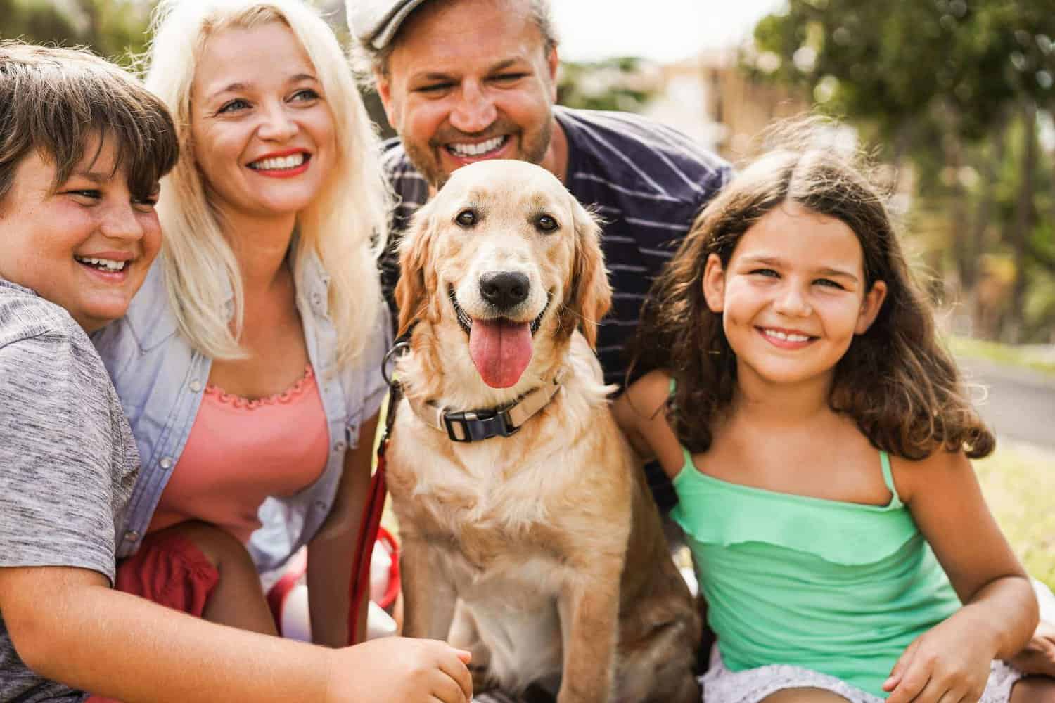 This is a family holding their dog and enjoying their pet-friendly accommodation Margaret River