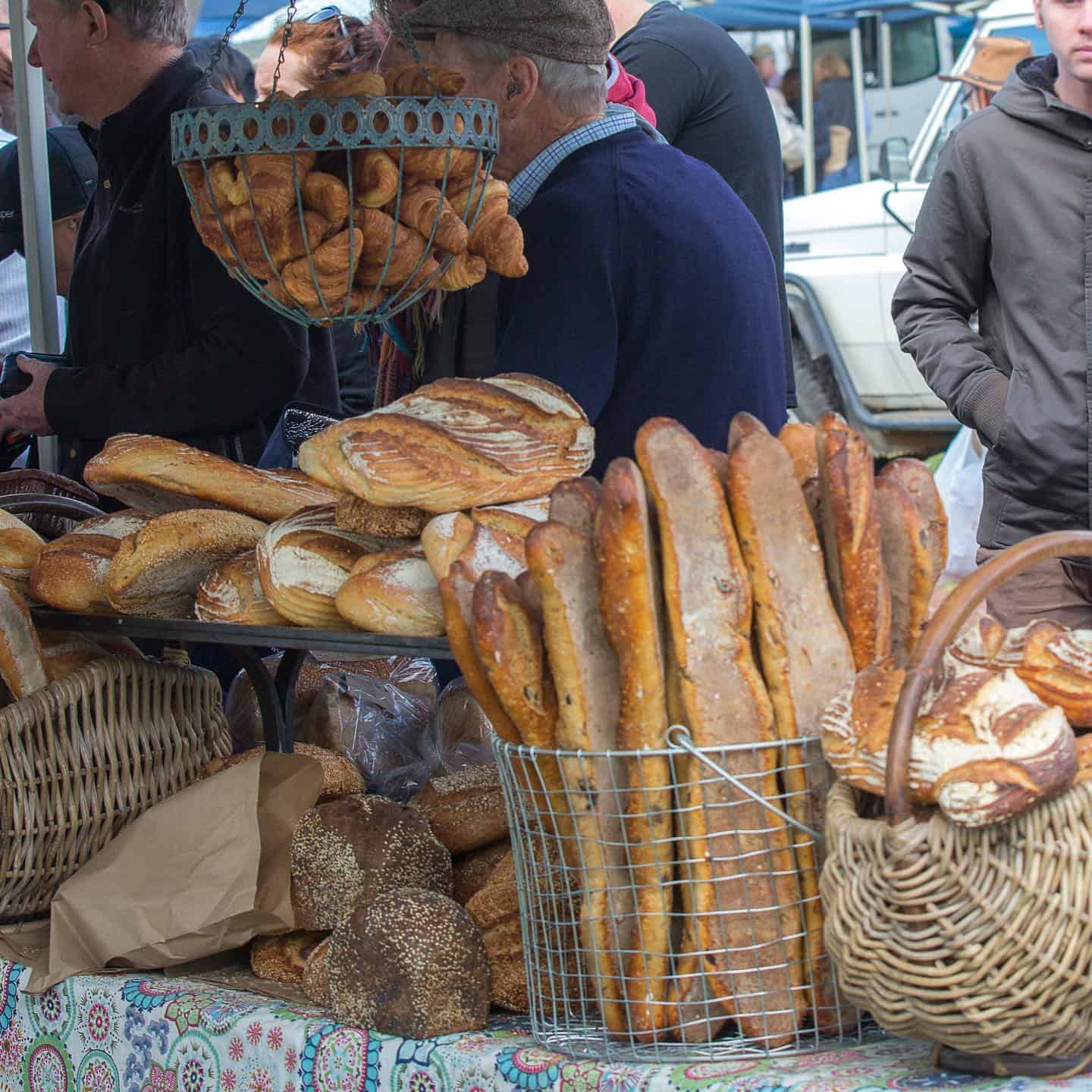 Artisanal bread stall at Margaret River Farmers Market, showcasing a variety of freshly baked goods, symbolizing the region's rich food culture.