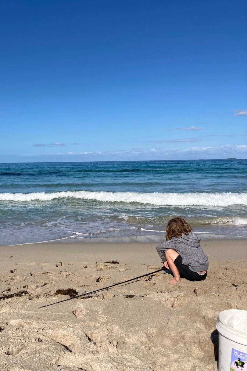 boy fishing from beach in Margaret River