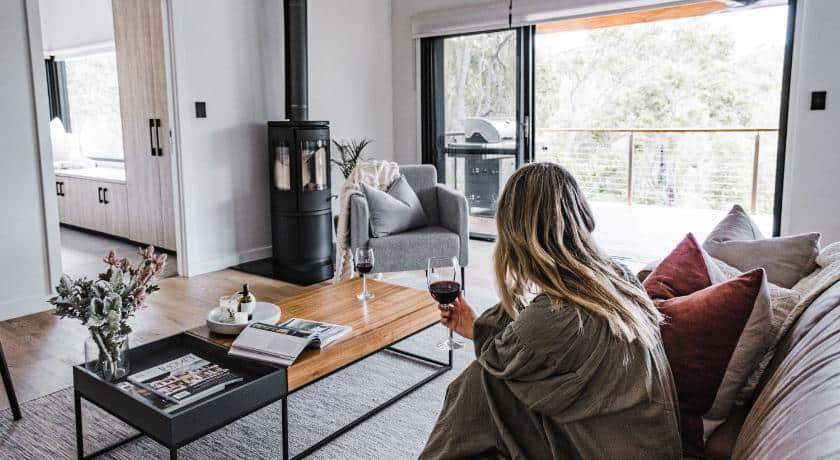 View of woman sitting in lounge of luxury accommodation Margaret River at Bina Maya Yallingup Escape