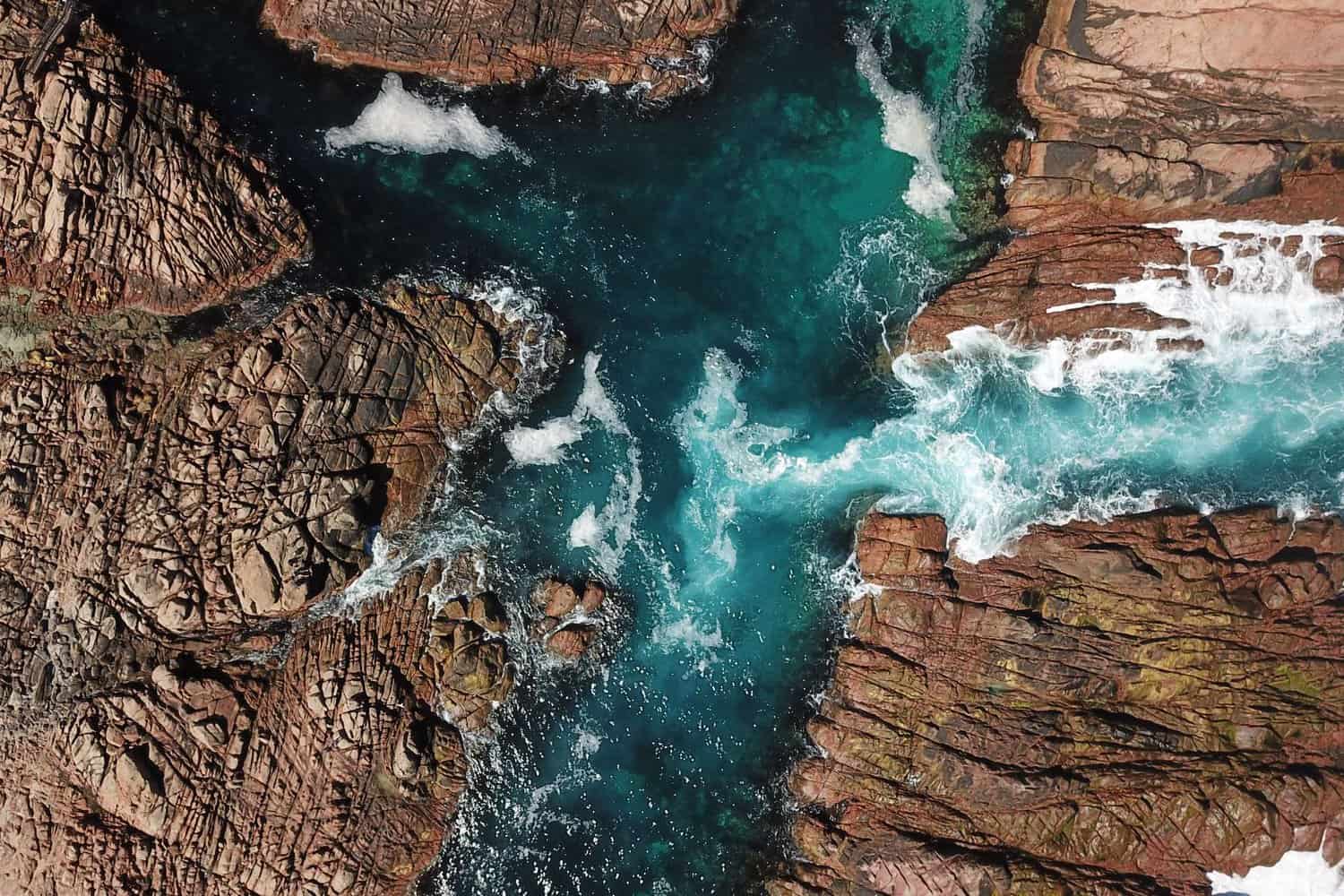 Aerial view of the rugged cliff formations along Margaret River, above Canal Rocks, where the powerful waves of the Indian Ocean sculpt the coastline.