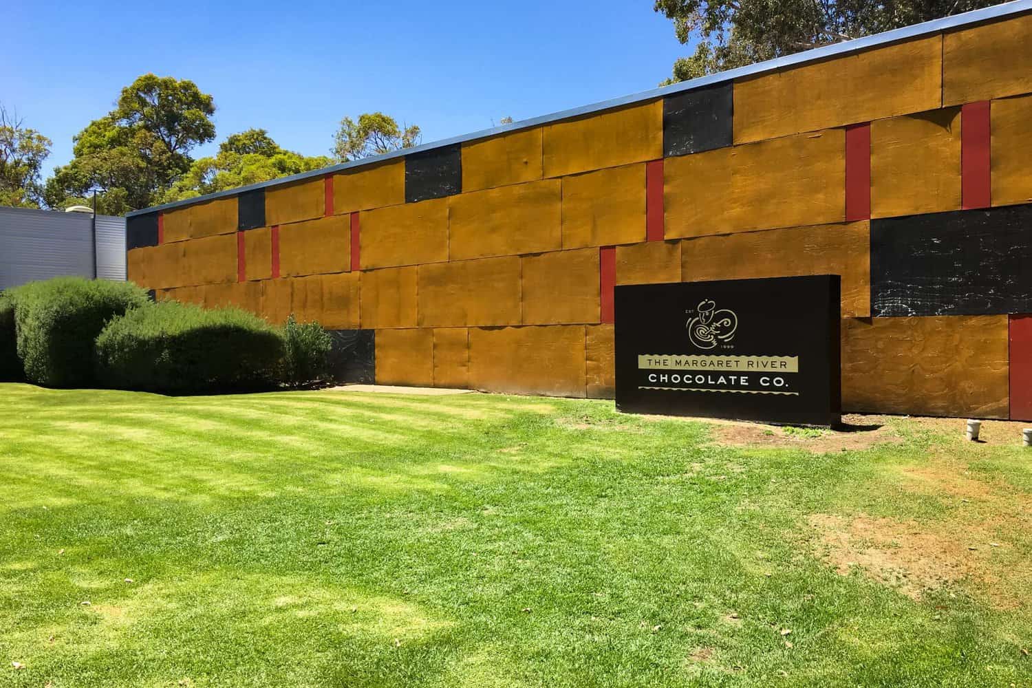 The vibrant facade of The Margaret River Chocolate Company, with its bold golden and black design, inviting visitors to one of the sweetest things to do in Margaret River.