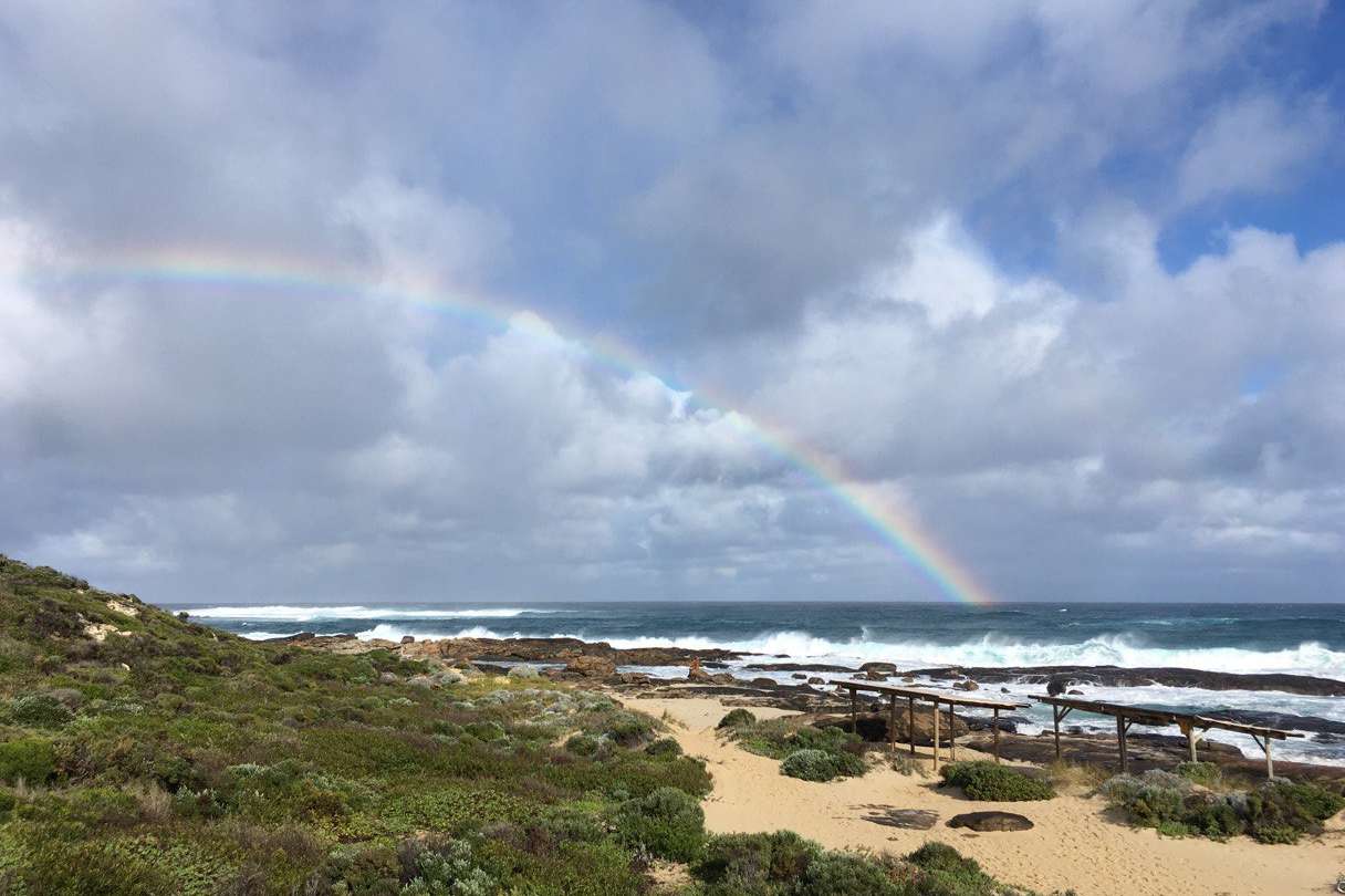 rainbow over margaret river mouth beach
