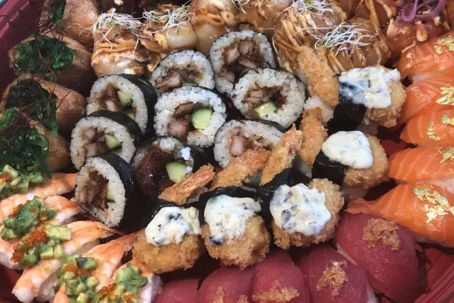 A delightful sushi plate filled with an assortment of colorful rolls, neatly arranged on a serving dish. The rolls showcase a variety of ingredients, including fresh fish, crisp vegetables, and creamy avocado, showing a tantalizing sushi takeaway option in Margaret River