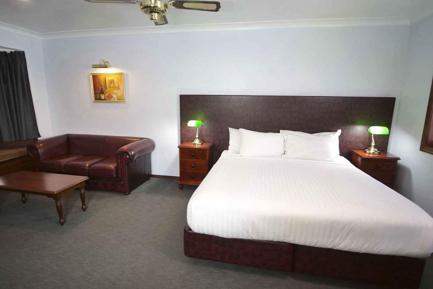 Image of king sized bed in hotel room, one of the different room types in a hotel